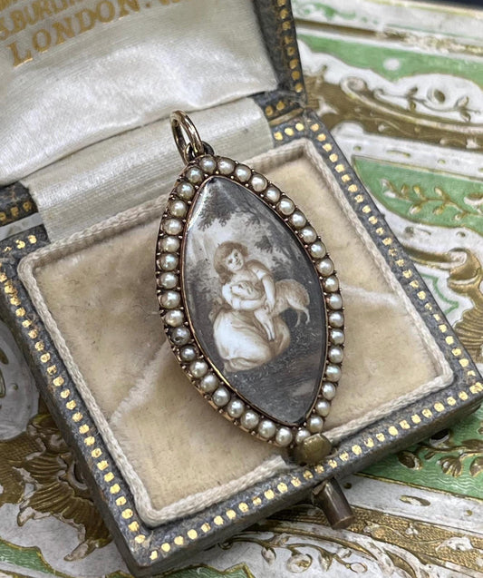 A navette shaped yellow gold seed pearl pendant with a miniature portrait, in an antique box