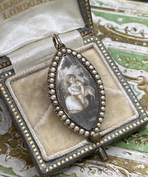 A navette shaped yellow gold seed pearl pendant with a miniature portrait, in an antique box