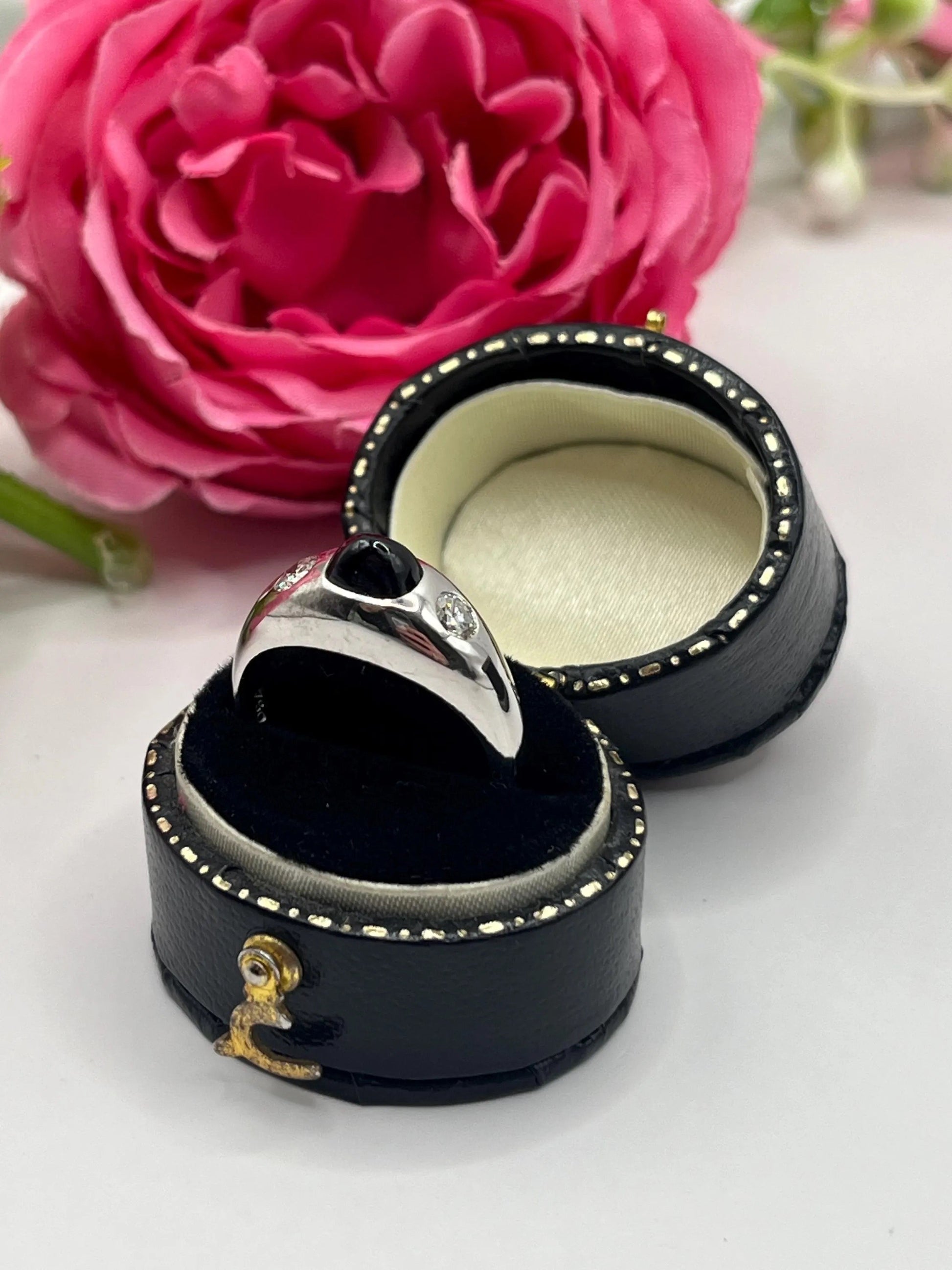 A cabochon sapphire and round diamond three stone band ring in white gold, in a ring box