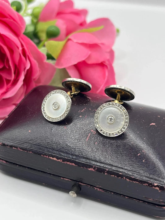 A pair of round diamond and mother of pearl cufflinks in yellow and white gold