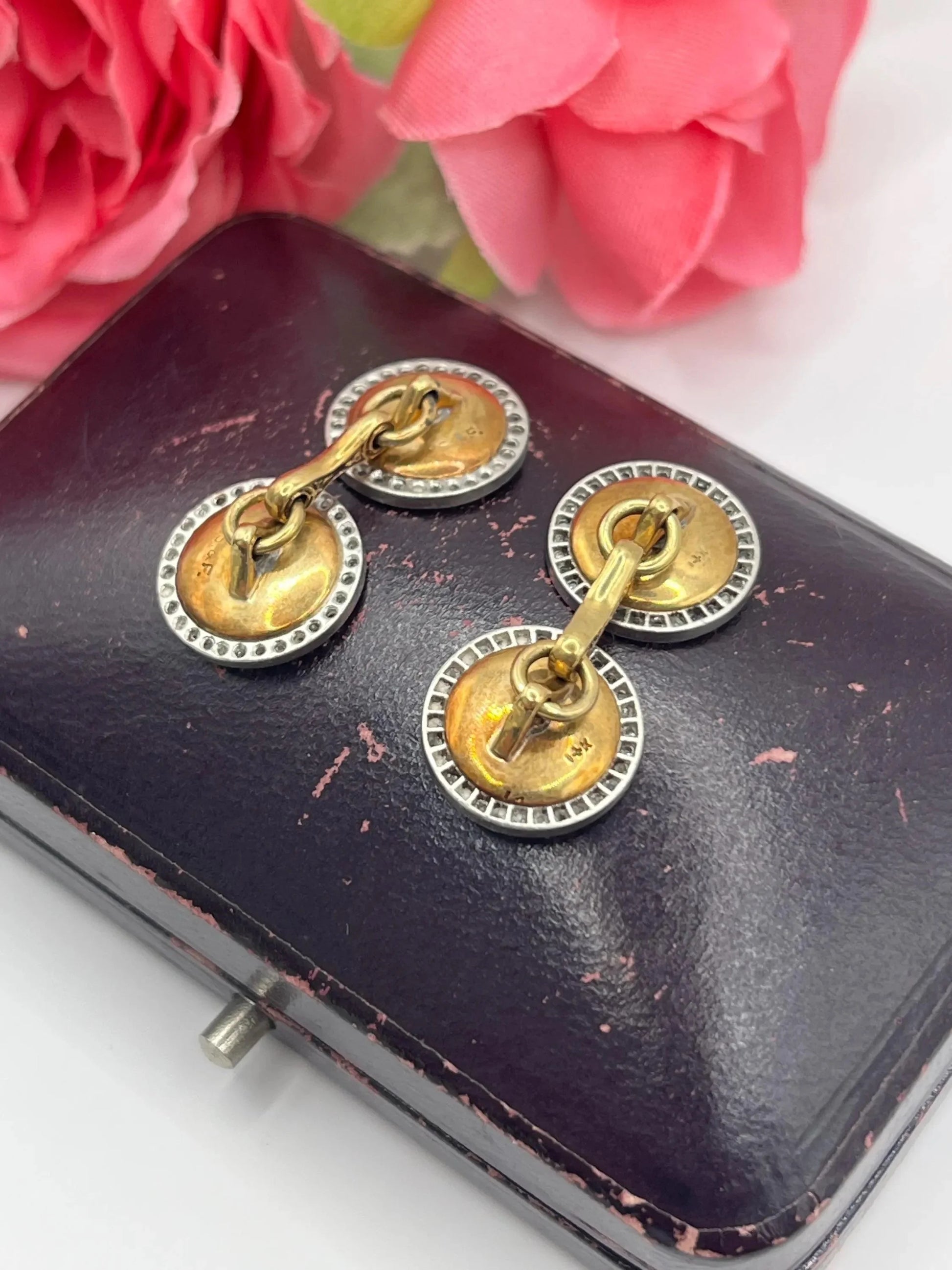 A pair of round diamond and mother of pearl cufflinks in yellow and white gold