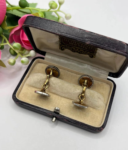 A pair of round diamond and mother of pearl cufflinks in yellow and white gold in an antique box