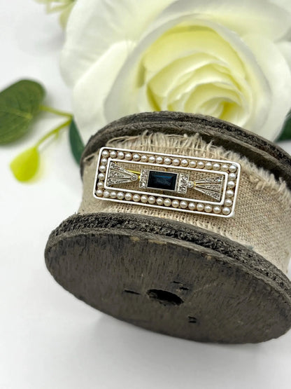 A rectangular brooch with sapphire, pearls and diamonds in gold and platinum