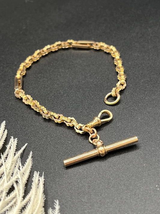 A yellow gold fancy link bracelet with T-bar