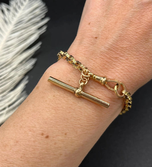 A yellow gold fancy link bracelet with T-bar, modelled on a wrist