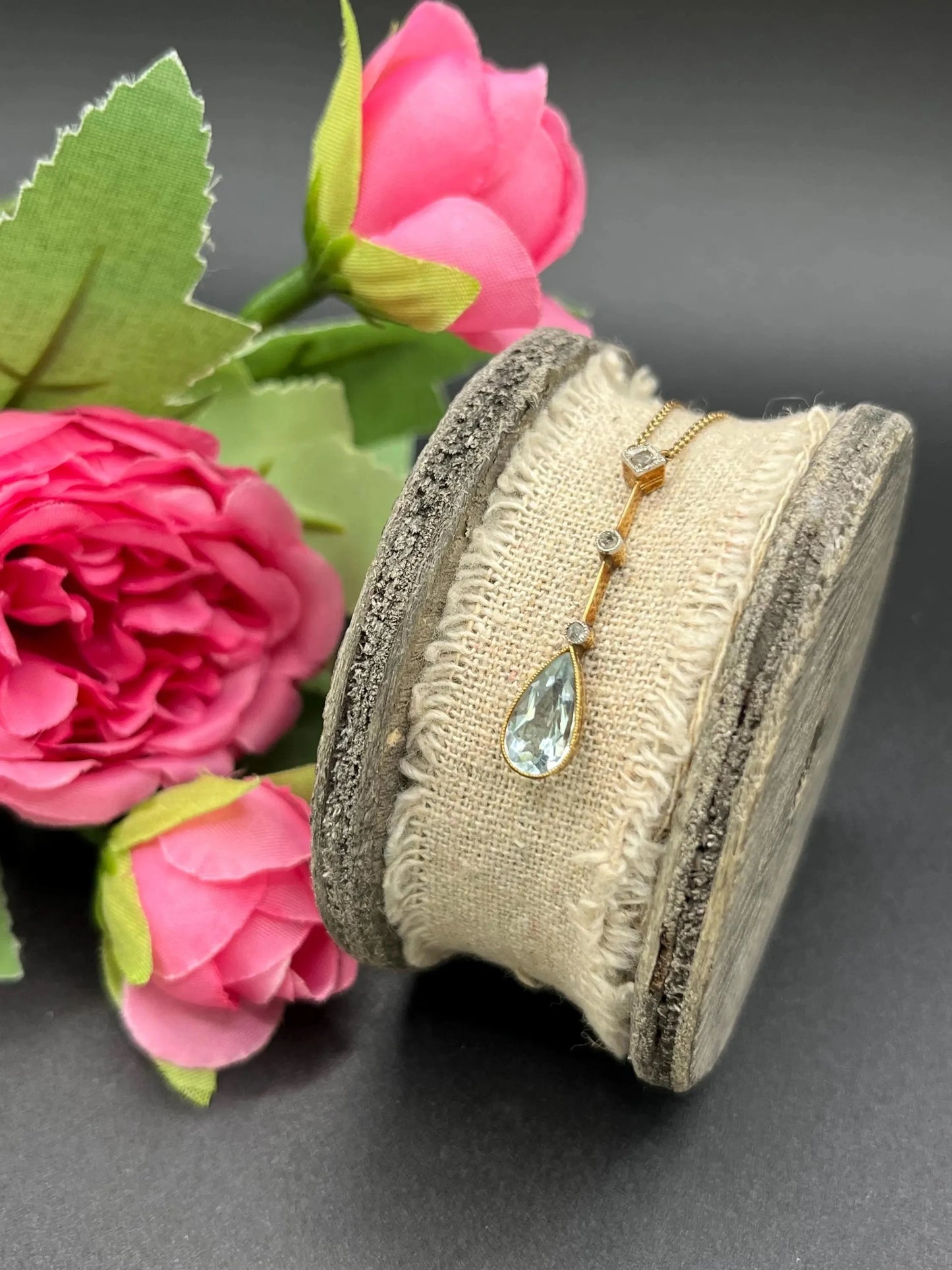 A pear shaped aquamarine and diamond drop pendant necklace in yellow gold