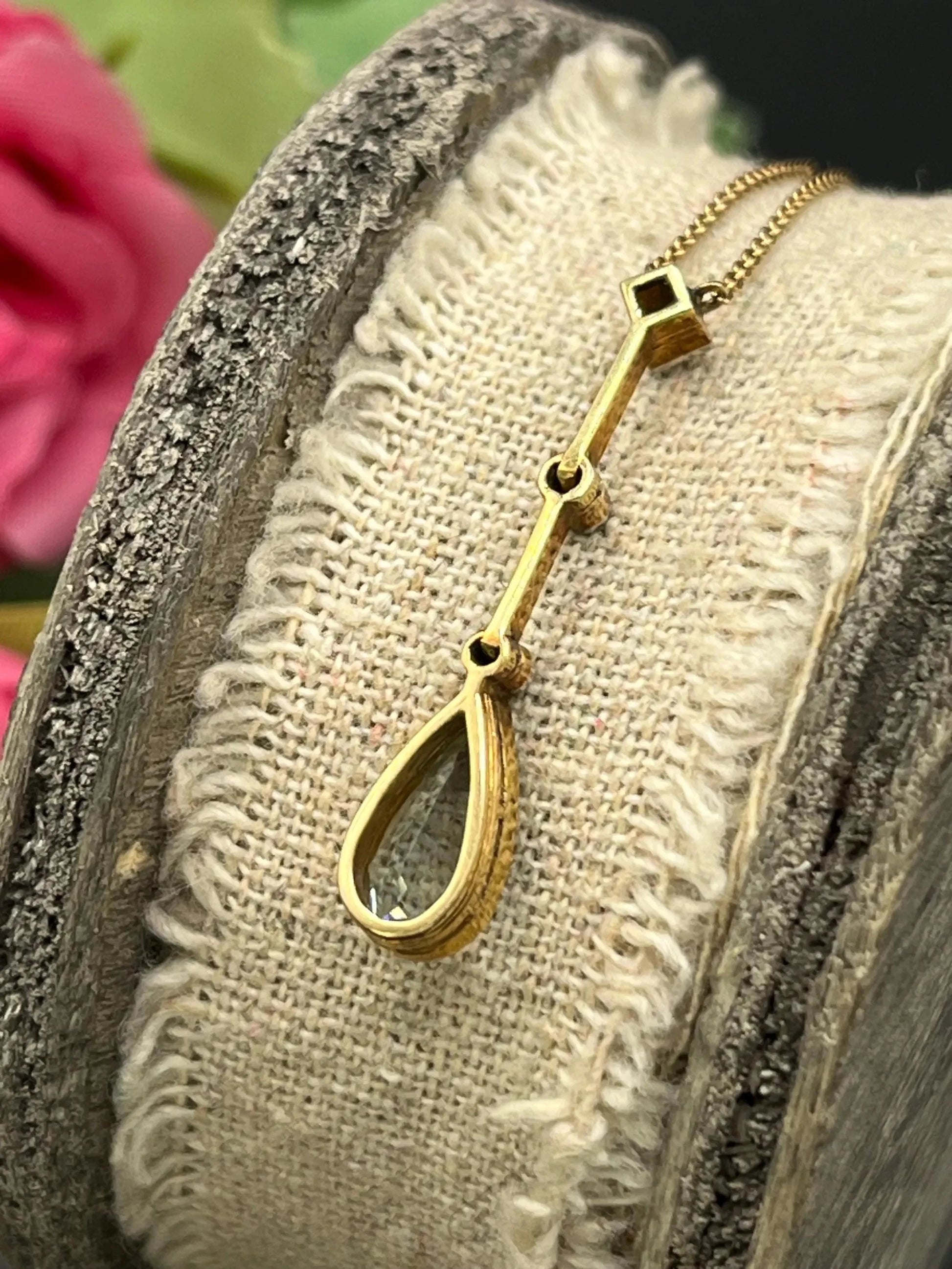 A pear shaped aquamarine and diamond drop pendant necklace in yellow gold