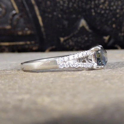 Teal sapphire and diamond ring in platinum.