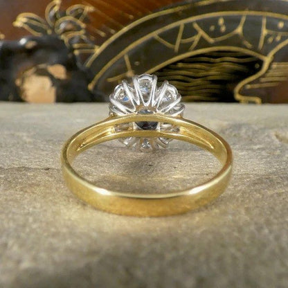 Sapphire and diamond oval cluster ring in yellow and white gold.