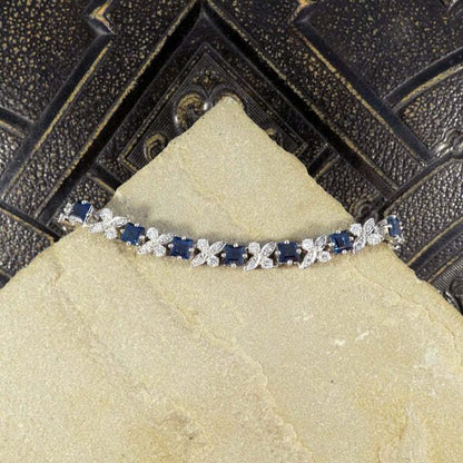 Sapphire and diamond line bracelet in white gold.
