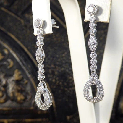 Diamond set drop earrings in white gold.