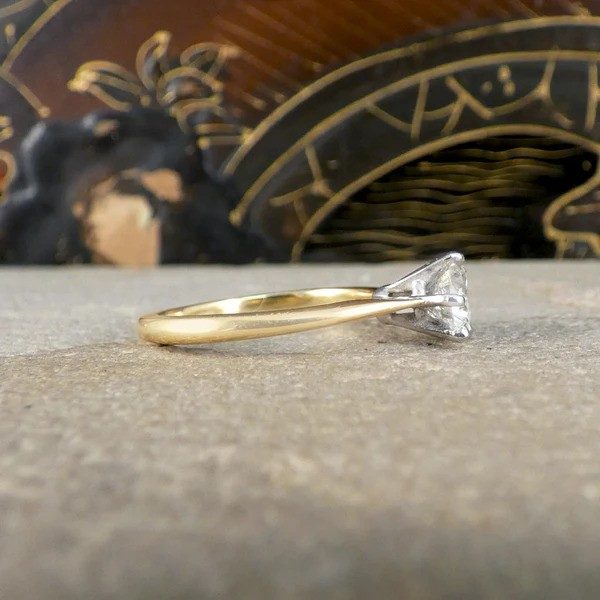 Diamond solitaire ring in yellow and white gold.