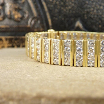 Diamond panel link bracelet in 14 carat yellow gold.