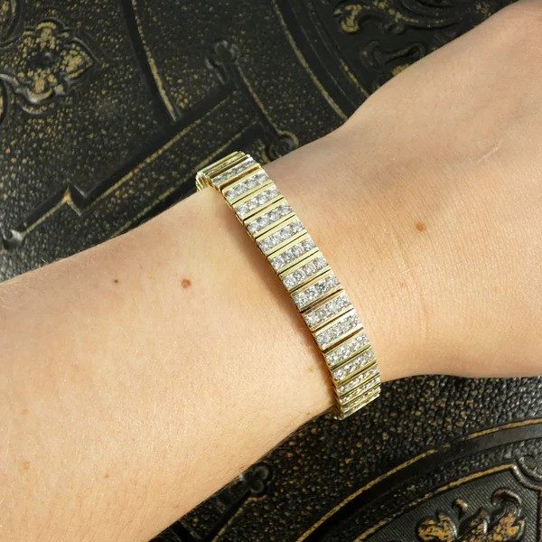 Diamond panel link bracelet in 14 carat yellow gold.