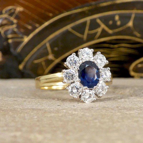 Sapphire and diamond oval cluster ring in yellow and white gold.