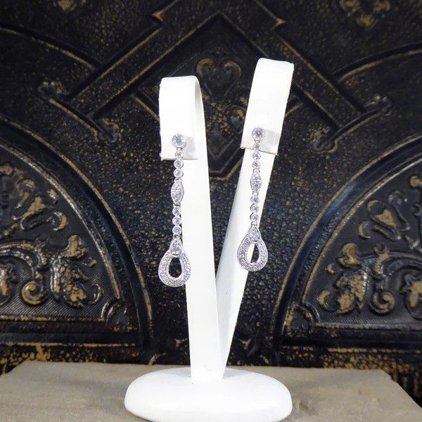 Diamond set drop earrings in white gold.