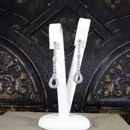 Diamond set drop earrings in white gold.