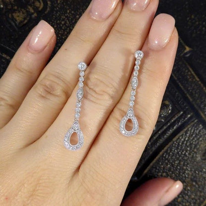 Diamond set drop earrings in white gold.