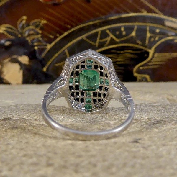Emerald, onyx and diamond cluster ring in platinum.