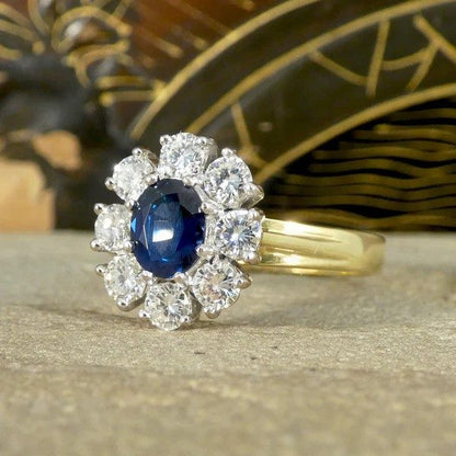 Sapphire and diamond oval cluster ring in yellow and white gold.