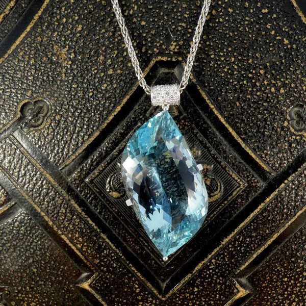 Aquamarine and diamond pendant with white gold chain.