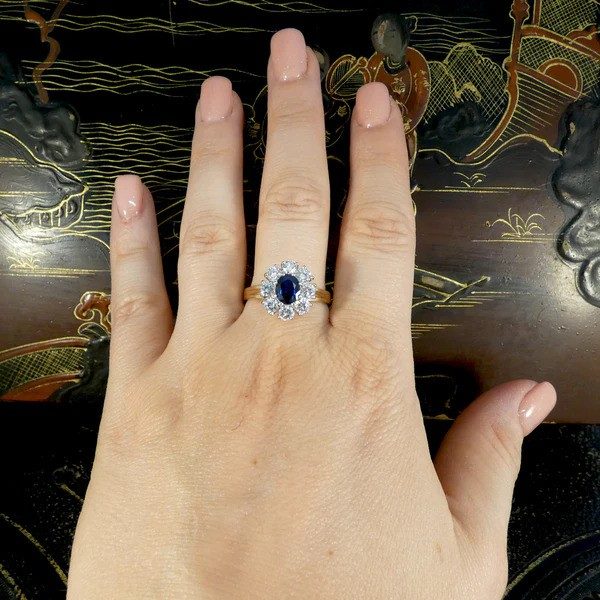 Sapphire and diamond oval cluster ring in yellow and white gold.