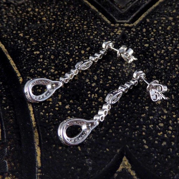 Diamond set drop earrings in white gold.