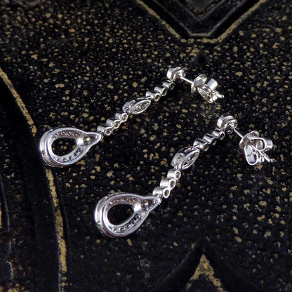 Diamond set drop earrings in white gold.