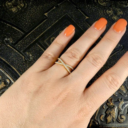 Diamond crossover ring in yellow gold.