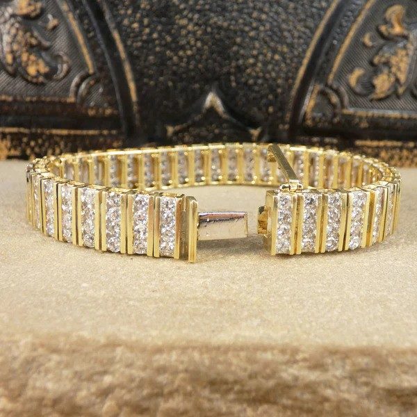 Diamond panel link bracelet in 14 carat yellow gold.