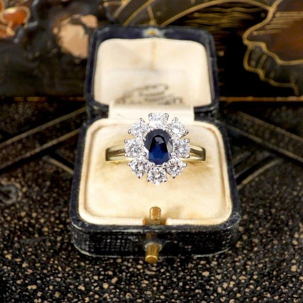 Sapphire and diamond oval cluster ring in yellow and white gold.