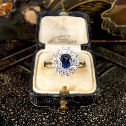 Sapphire and diamond oval cluster ring in yellow and white gold.