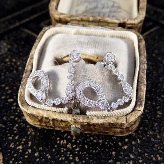 Diamond set drop earrings in white gold.