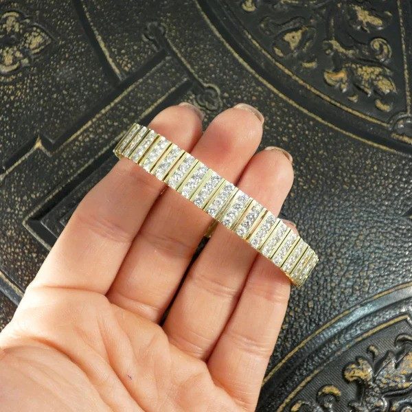 Diamond panel link bracelet in 14 carat yellow gold.
