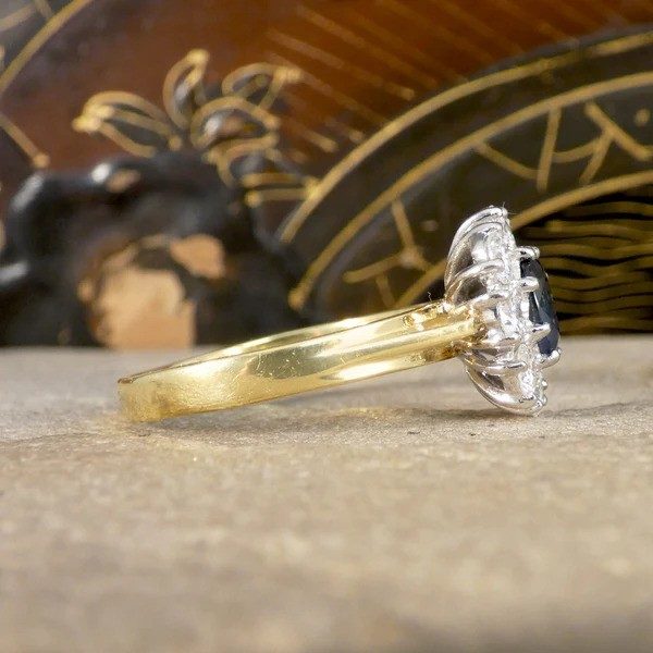 Sapphire and diamond oval cluster ring in yellow and white gold.