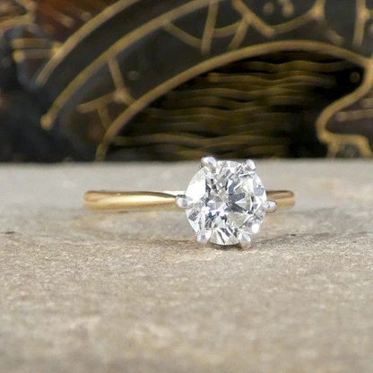 Diamond solitaire ring in yellow and white gold.