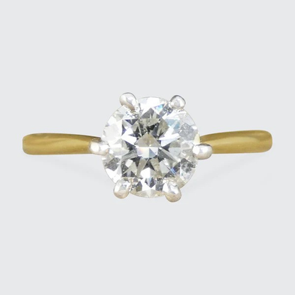 Diamond solitaire ring in yellow and white gold.