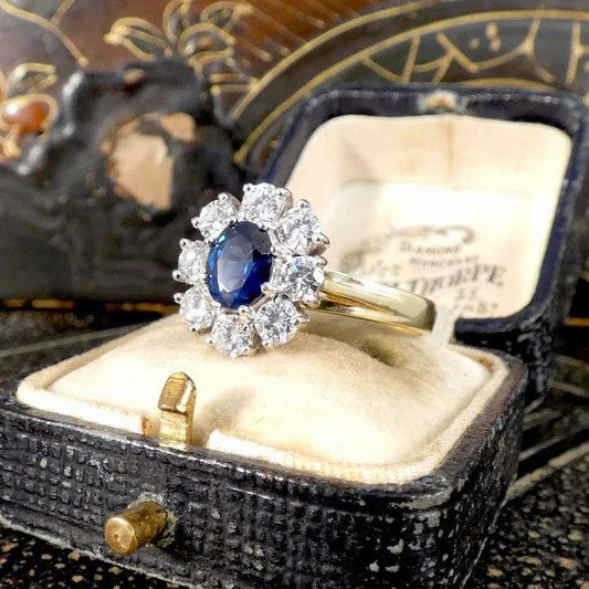 Sapphire and diamond oval cluster ring in yellow and white gold.