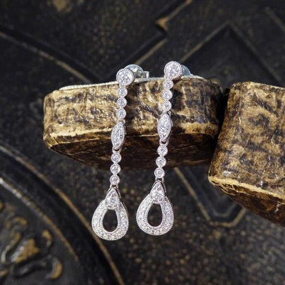 Diamond set drop earrings in white gold.