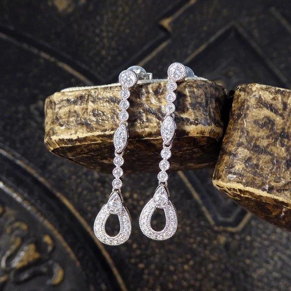 Diamond set drop earrings in white gold.