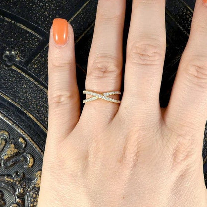 Diamond crossover ring in yellow gold.