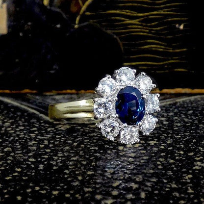 Sapphire and diamond oval cluster ring in yellow and white gold.