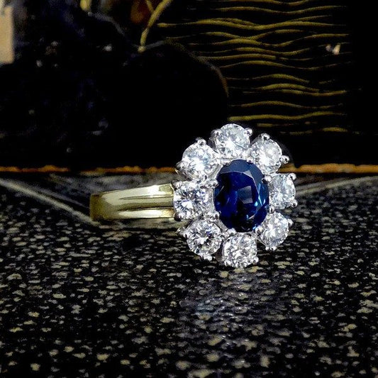 Sapphire and diamond oval cluster ring in yellow and white gold.