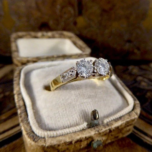 Diamond two stone ring set in white and yellow gold. 