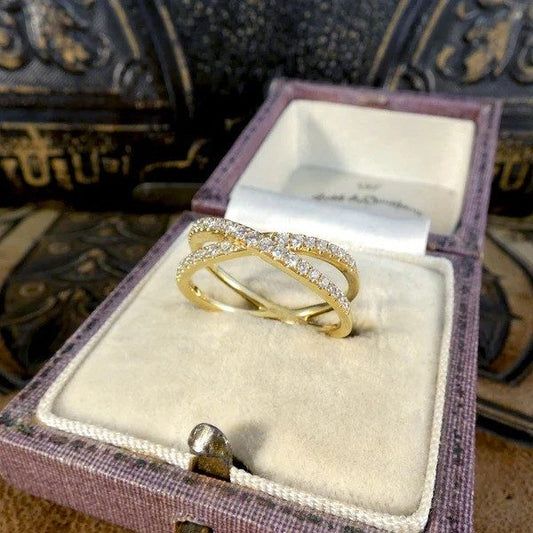 Diamond crossover ring in yellow gold.