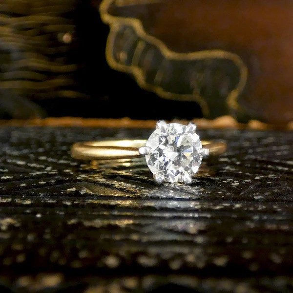 Diamond solitaire ring in yellow and white gold.