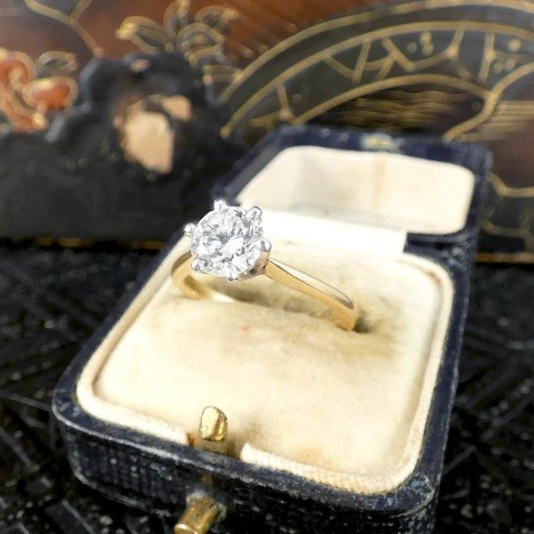 Diamond solitaire ring in yellow and white gold.
