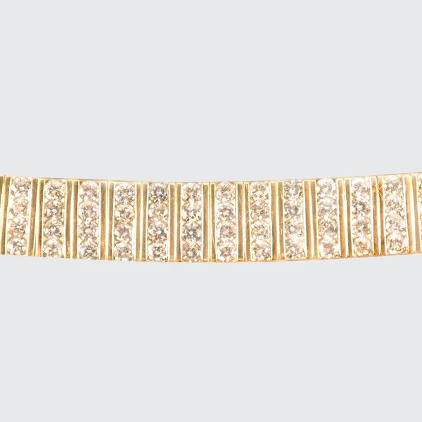 Diamond panel link bracelet in 14 carat yellow gold.