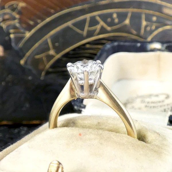 Diamond solitaire ring in yellow and white gold.