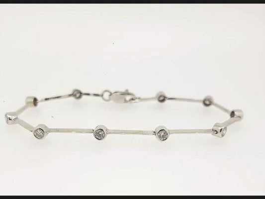 Diamond set Bar Bracelet; a delicate bar bracelet embracing bezel set round cut diamonds totaling 1.20 carats